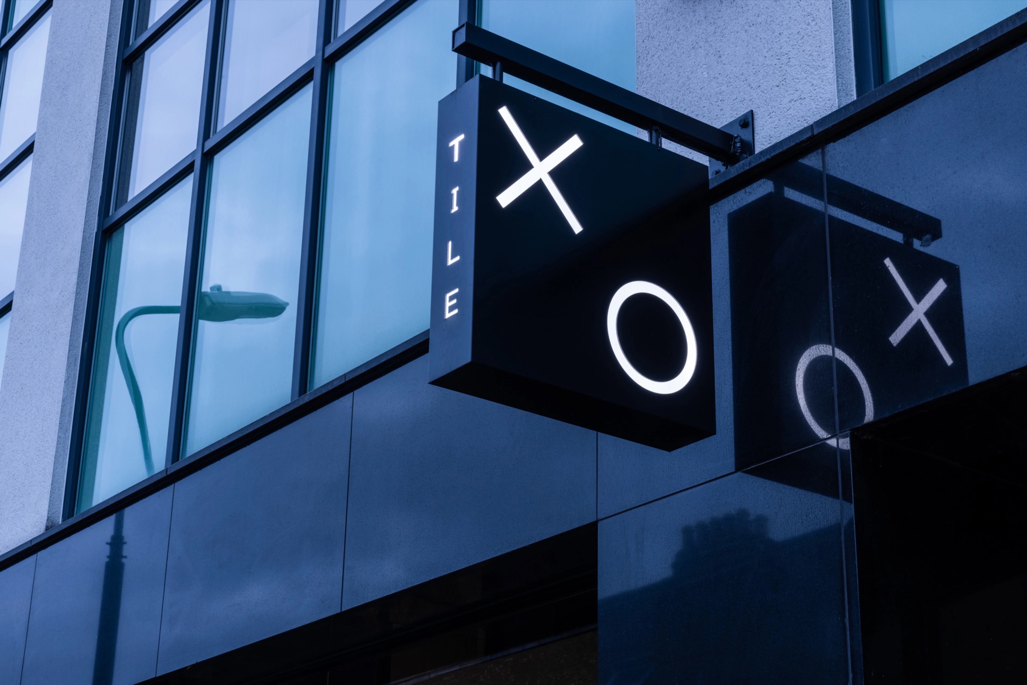 The illuminated XO sign at dusk.